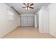 Spacious garage with ample storage, tiled flooring, and a convenient side door for easy access at 21 Pine Trace Run, Ocala, FL 34472