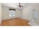 Bright living room featuring tile flooring, a ceiling fan, and natural light, perfect for relaxation or entertaining at 21 Pine Trace Run, Ocala, FL 34472