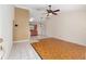 Bright living area with tile flooring, a ceiling fan, and an open view of the kitchen at 21 Pine Trace Run, Ocala, FL 34472