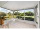 Enclosed, screened-in porch is ideal for relaxing with outdoor view of the lush greenery at 21 Pine Trace Run, Ocala, FL 34472