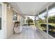 Outdoor screened-in porch offers views of lush landscape, perfect for relaxing in privacy at 21 Pine Trace Run, Ocala, FL 34472