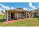 View of storage shed with open access and shaded porch at 21 Pine Trace Run, Ocala, FL 34472