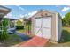 Storage shed, with access ramp, located in the backyard at 21 Pine Trace Run, Ocala, FL 34472