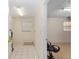 Functional utility room with water heater, tiled floor, and natural light from the window at 21 Pine Trace Run, Ocala, FL 34472