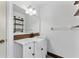 Chic bathroom featuring a single sink vanity with marble counters and wooden accents at 2146 Ne 9Th St, Ocala, FL 34470
