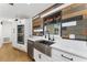 Modern kitchen with stainless steel appliances, farmhouse sink, and wood accent wall at 2146 Ne 9Th St, Ocala, FL 34470