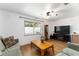 The living room features wood floors, neutral furniture, and a large television at 2146 Ne 9Th St, Ocala, FL 34470