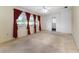 Bright living room with large windows, red curtains, and ceiling fan at 2146 Ne 9Th St, Ocala, FL 34470