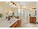 Bright bathroom featuring dual sinks, tile flooring, and walk-in shower with glass enclosure at 2631 Sw 20Th Cir, Ocala, FL 34471
