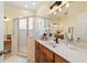 Bathroom featuring double sinks, spacious countertops, and tiled shower with glass doors at 2631 Sw 20Th Cir, Ocala, FL 34471