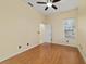 Bedroom with ceiling fan, wood flooring, window, and door to bathroom at 2631 Sw 20Th Cir, Ocala, FL 34471