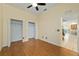 Bedroom with ceiling fan, wood flooring, and double door closets at 2631 Sw 20Th Cir, Ocala, FL 34471