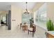 Bright breakfast nook featuring a round table, large windows, and stylish chandelier at 2631 Sw 20Th Cir, Ocala, FL 34471