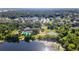 Aerial showcasing community amenities, including pool, lake, tennis courts, and lush trees at 2631 Sw 20Th Cir, Ocala, FL 34471