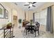 Dining area with a dark wood table set for four, large windows, and neutral-toned walls at 2631 Sw 20Th Cir, Ocala, FL 34471