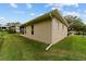 Rear exterior view shows roofline, siding, and lawn, revealing the home's simple and clean architectural design at 2631 Sw 20Th Cir, Ocala, FL 34471