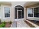 Inviting screened front entrance with tiled walkway and manicured flower beds at 2631 Sw 20Th Cir, Ocala, FL 34471