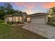 Dusk view of the single Gathering home with a large brick driveway, and green grass at 2631 Sw 20Th Cir, Ocala, FL 34471