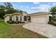 Beautiful single Gathering home with brick driveway, green lawn, and lovely landscaping at 2631 Sw 20Th Cir, Ocala, FL 34471