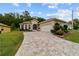 Attractive single Gathering home with beautiful brick driveway, well-kept lawn and charming landscaping at 2631 Sw 20Th Cir, Ocala, FL 34471