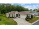 Charming home features a beautiful brick driveway, manicured landscaping, and attached two-car garage at 2631 Sw 20Th Cir, Ocala, FL 34471