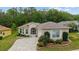 Quaint single Gathering home boasts a brick driveway, attached garage, and beautiful landscaping at 2631 Sw 20Th Cir, Ocala, FL 34471