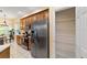 Kitchen view with stainless steel refrigerator, wood cabinets and a walk-in pantry at 2631 Sw 20Th Cir, Ocala, FL 34471