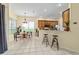 Open concept kitchen and living area with tiled floors, kitchen island, and barstool seating at 2631 Sw 20Th Cir, Ocala, FL 34471