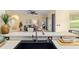 Kitchen area with sink and view of the living room featuring an open-concept design at 2631 Sw 20Th Cir, Ocala, FL 34471
