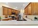 Well-lit kitchen featuring wood cabinetry, stainless steel appliances, and stone countertops at 2631 Sw 20Th Cir, Ocala, FL 34471