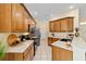 Well-lit kitchen featuring wooden cabinetry, stainless steel appliances, and a spacious countertop at 2631 Sw 20Th Cir, Ocala, FL 34471