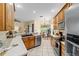 Spacious kitchen featuring wood cabinetry, stainless steel appliances, and view to the dining area at 2631 Sw 20Th Cir, Ocala, FL 34471