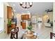 Open-concept kitchen and dining area with wood cabinets, stainless steel appliances, and tile flooring at 2631 Sw 20Th Cir, Ocala, FL 34471