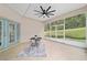 Covered lanai with backyard views, tiled floor, and ceiling fan, ideal for relaxation and enjoying the outdoors at 2631 Sw 20Th Cir, Ocala, FL 34471