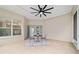 Covered patio with tiled floor, ceiling fan, and backyard view, ideal for outdoor entertaining and relaxing at 2631 Sw 20Th Cir, Ocala, FL 34471