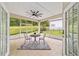 Enclosed lanai with tiled floor, ceiling fan, and backyard views, perfect for outdoor relaxation and enjoyment at 2631 Sw 20Th Cir, Ocala, FL 34471