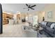 Open-concept living room with tile flooring, breakfast bar, and view to kitchen at 2631 Sw 20Th Cir, Ocala, FL 34471