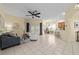 Bright living room featuring tiled floors, ceiling fan, and access to a patio with an outdoor living space at 2631 Sw 20Th Cir, Ocala, FL 34471