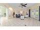 Open living room with tile flooring, ceiling fan, neutral colors, and lots of light at 2631 Sw 20Th Cir, Ocala, FL 34471