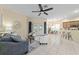 Open living room with tile floors, ceiling fan, and a view of the kitchen at 2631 Sw 20Th Cir, Ocala, FL 34471