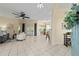 Open-concept living room with tile flooring, ceiling fan and access to outdoor patio at 2631 Sw 20Th Cir, Ocala, FL 34471
