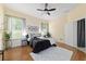 Bedroom featuring hardwood floors, a ceiling fan, and windows for natural lighting at 2631 Sw 20Th Cir, Ocala, FL 34471