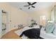 Main bedroom with wood floors, ensuite bath, ceiling fan, and bright neutral paint at 2631 Sw 20Th Cir, Ocala, FL 34471