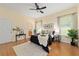 Spacious main bedroom featuring wood floors, a ceiling fan, and natural light at 2631 Sw 20Th Cir, Ocala, FL 34471