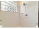 Shower featuring tiled walls, shower head with handle, and glass block window at 2631 Sw 20Th Cir, Ocala, FL 34471