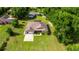 A beautiful aerial view showcasing a well-kept house with a spacious yard and mature trees at 465 Ne 155Th Street Rd, Citra, FL 32113