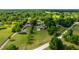 Aerial view of a property with a well-maintained lawn, mature trees and surrounding lush greenery at 465 Ne 155Th Street Rd, Citra, FL 32113