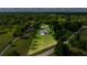Expansive aerial view of a home surrounded by lush greenery and a well-maintained lawn at 465 Ne 155Th Street Rd, Citra, FL 32113