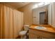 Functional bathroom featuring a toilet, vanity with sink, and a shower with a curtain at 465 Ne 155Th Street Rd, Citra, FL 32113