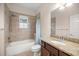 Bathroom with granite-look vanity, shower over tub and tiled walls at 465 Ne 155Th Street Rd, Citra, FL 32113
